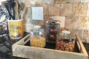 Empty glass candle jar being repurposed for storage